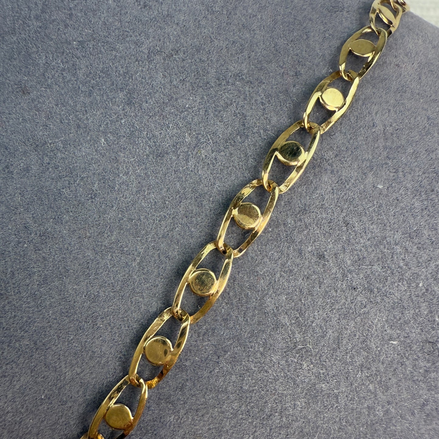 Close-up view of a gold fancy link bracelet.