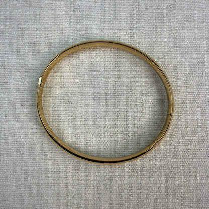 Top view of oval gold bangle.