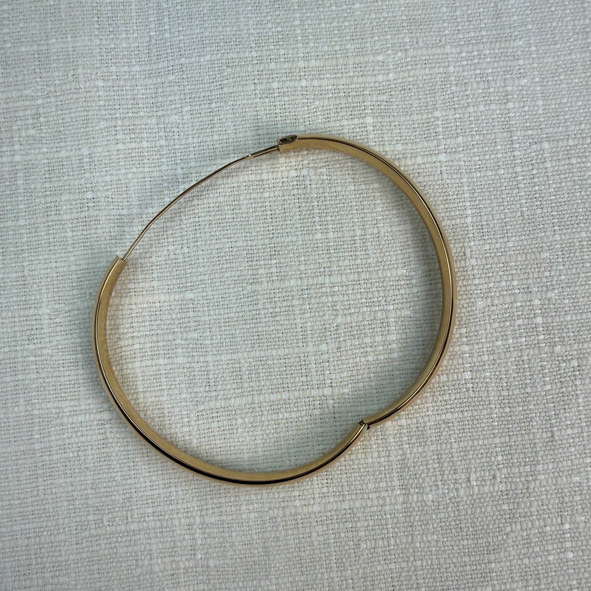Hinge opened on oval bangle.