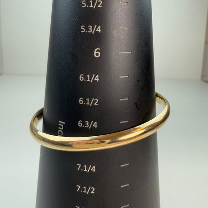 Oval bangle, approximately 7", shown on a black mandrel.