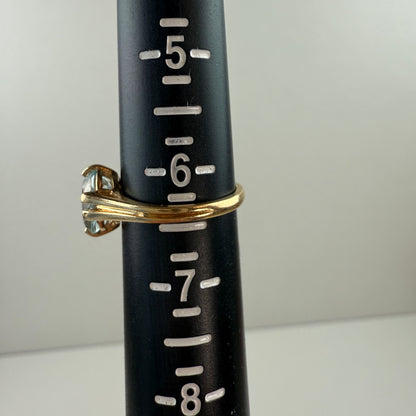 Black measuring tool with gold ring and clear gemstone on a white background