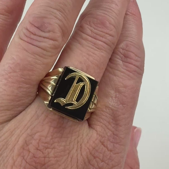 Video of a "D" signet ring on hand slowly moving