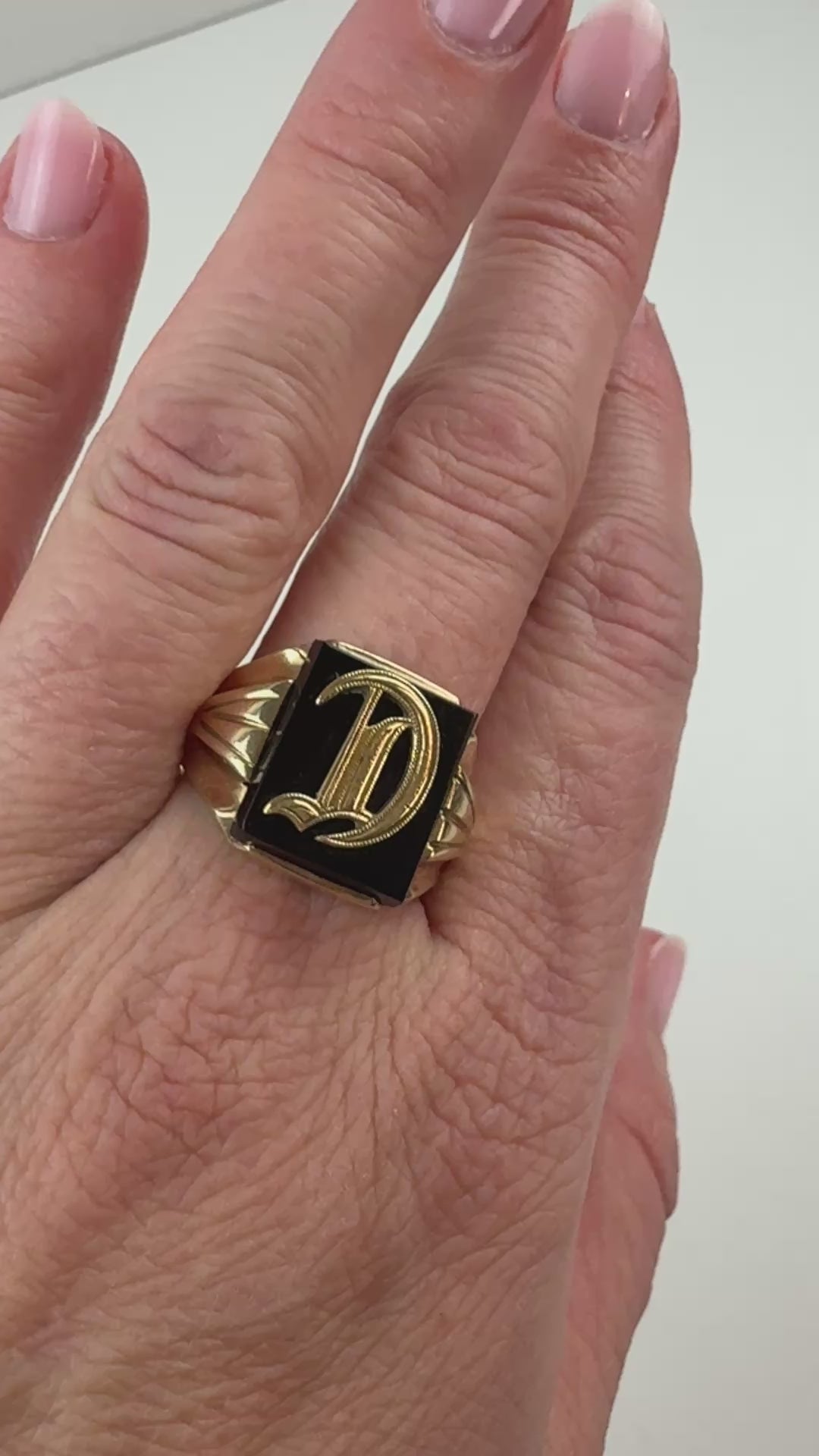 Video of a "D" signet ring on hand slowly moving