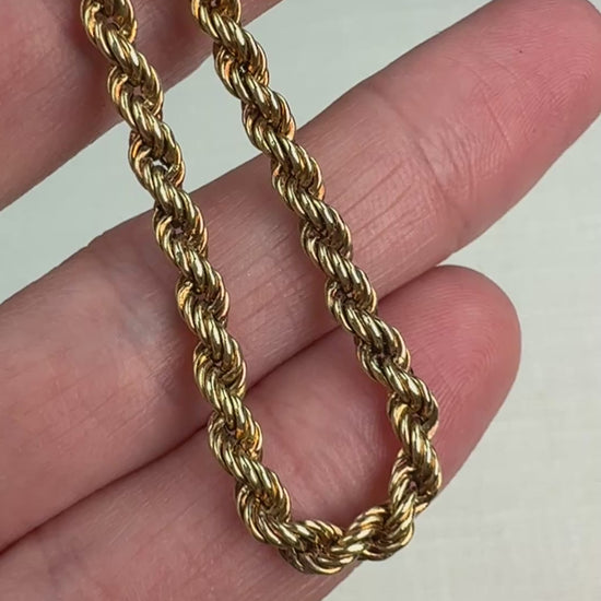 Short video of a gold rope chain gently moved in hand to show shine.