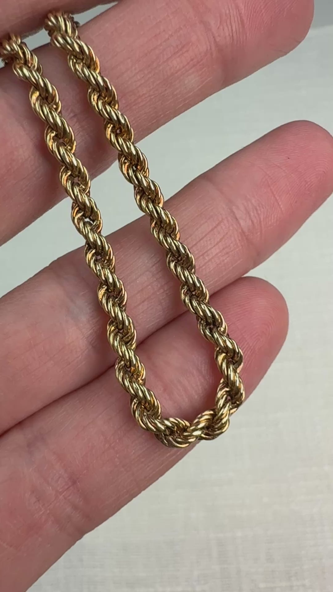 Short video of a gold rope chain gently moved in hand to show shine.